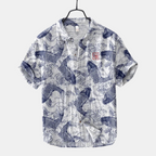 Front view of the Vintage Fish-Print Linen Shirt in blue, featuring a band collar, short sleeves, button-front closure, and a vintage-inspired fish print. Designed by Bella Hudson.