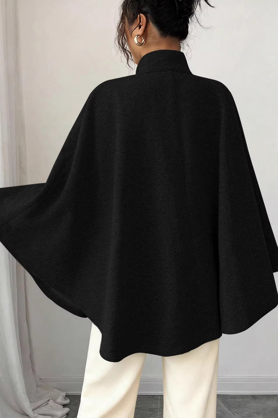 Vivian Black belted cape coat shown from the back with a flowing cape silhouette and wide draped sleeves
