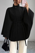 Vivian Black belted cape coat featuring a stand collar, wide cape-style sleeves, self-tie waist belt, and relaxed flared silhouette