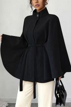 Vivian Black belted cape coat shown full length with a structured stand collar, flowing wide sleeves, and adjustable waist belt