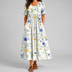 White floral maxi dress front view with blue and yellow flower print and pockets BELLA HUDSON