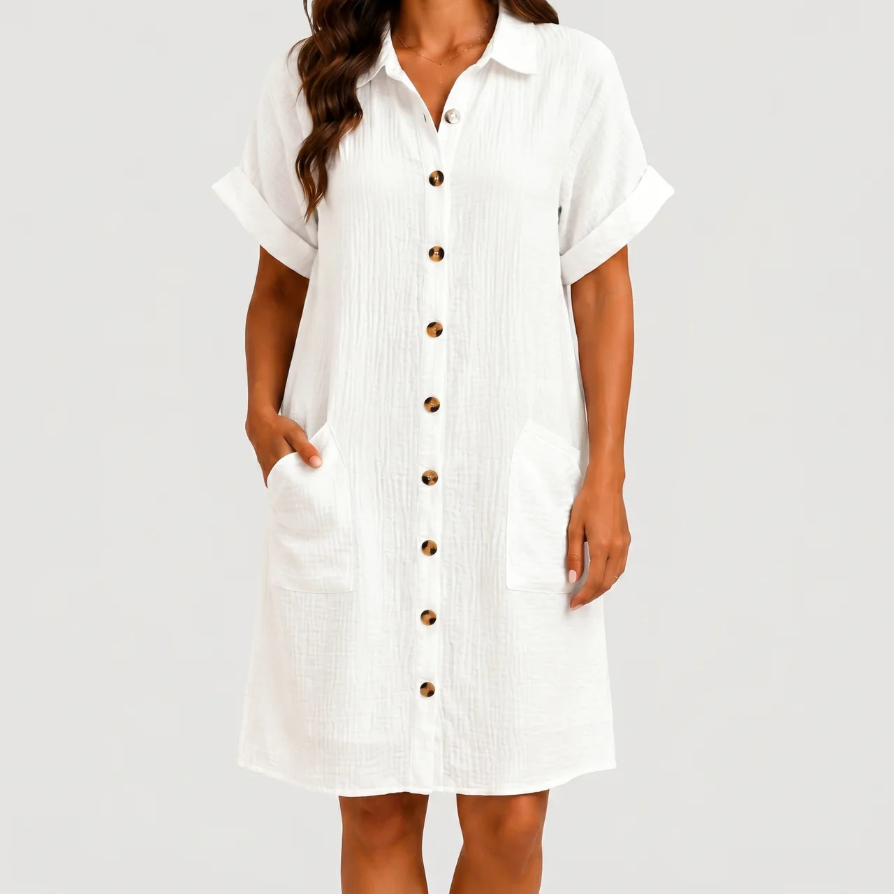 Front view of white button front midi dress with short sleeves and side pockets by BELLA HUDSON