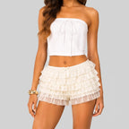 Front view of white C layered ruffle mini shorts with elastic waist by BELLA HUDSON