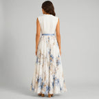 Back view of white floral V-neck maxi dress with sleeveless design and flowy silhouette by BELLA HUDSON