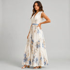 Side view of white floral V-neck maxi dress with sleeveless design and flowy silhouette by BELLA HUDSON