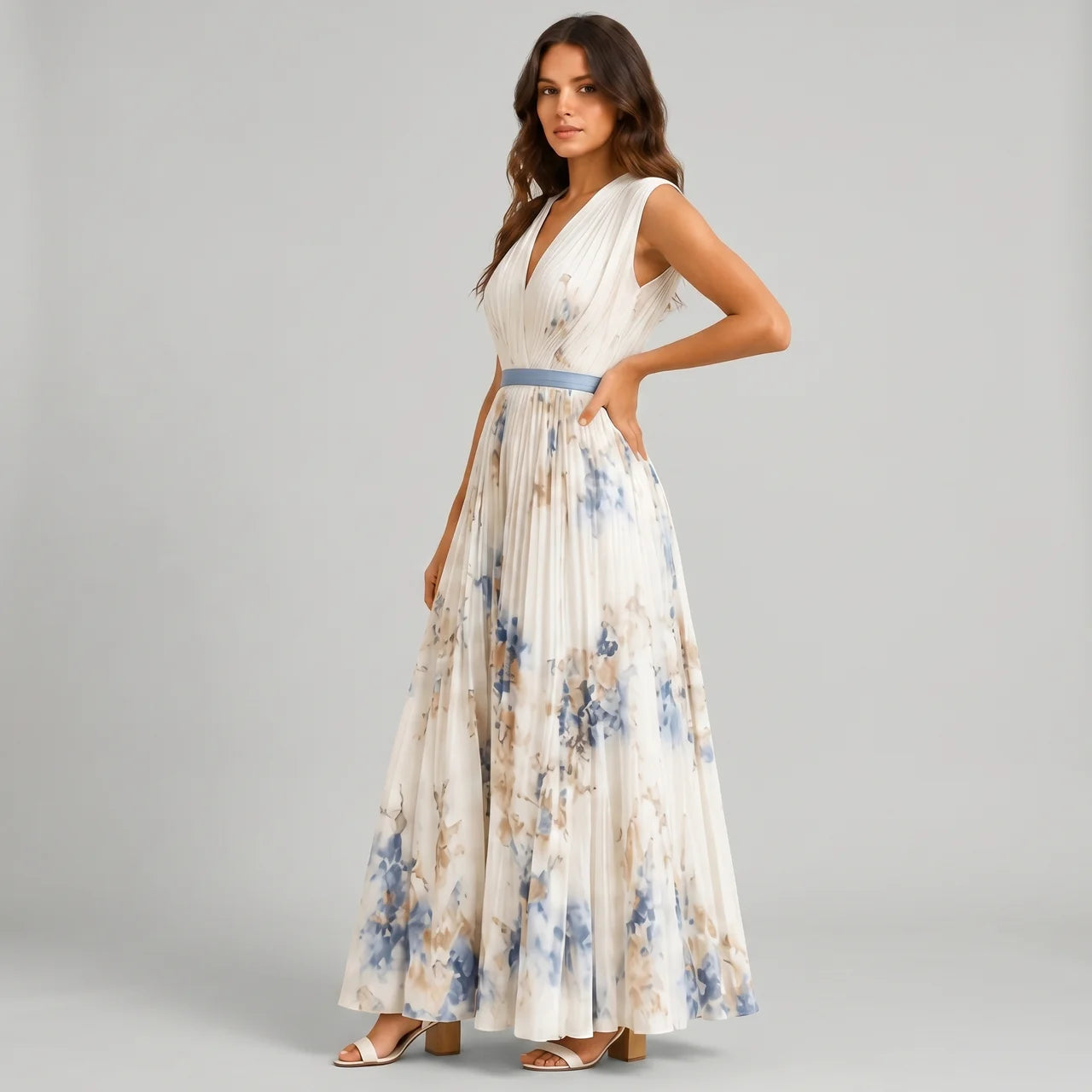 Side view of white floral V-neck maxi dress with sleeveless design and flowy silhouette by BELLA HUDSON