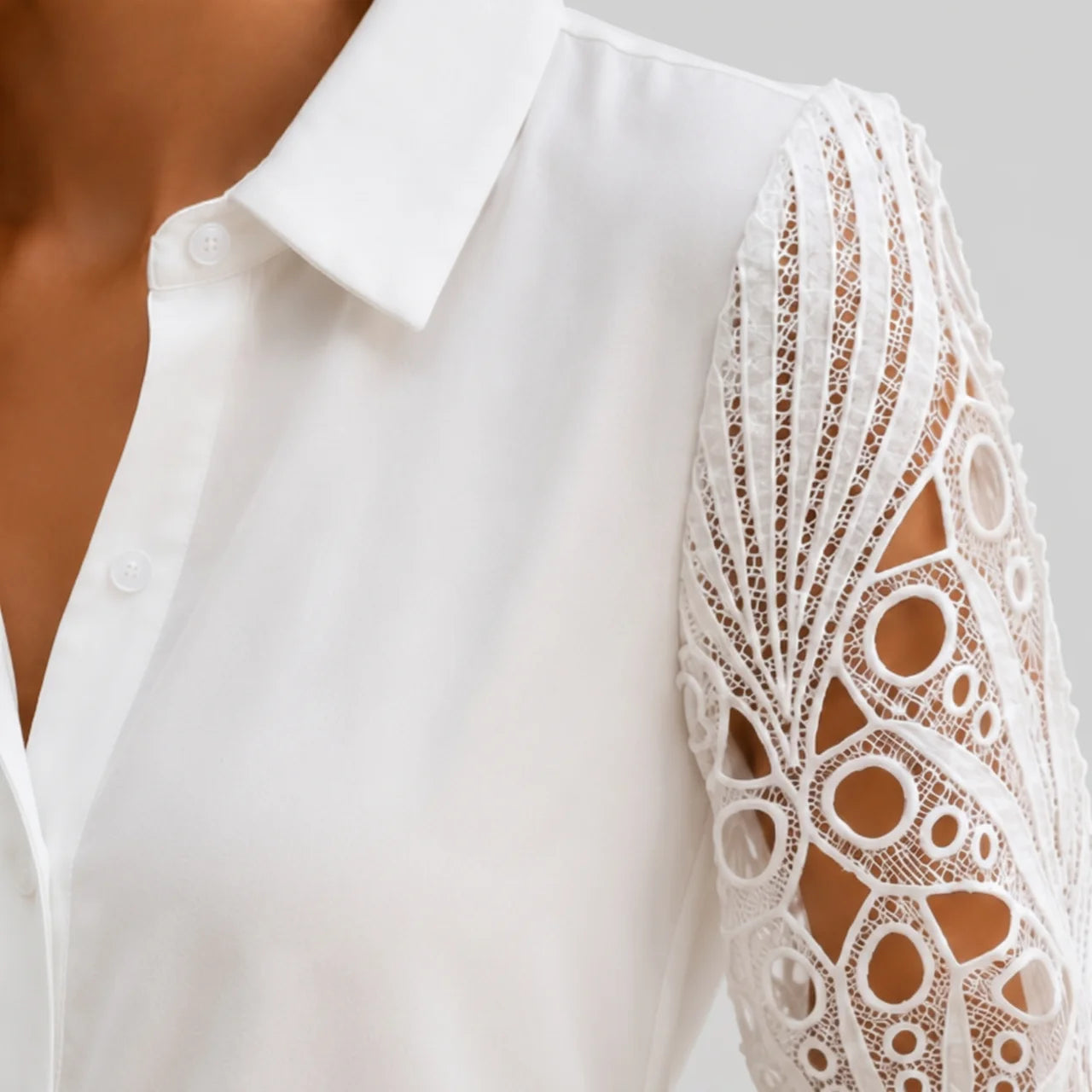 Close-up view of white lace sleeve blouse with long crochet sleeves and collared neckline by BELLA HUDSON