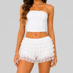 Front view of white layered ruffle mini shorts with elastic waist by BELLA HUDSON