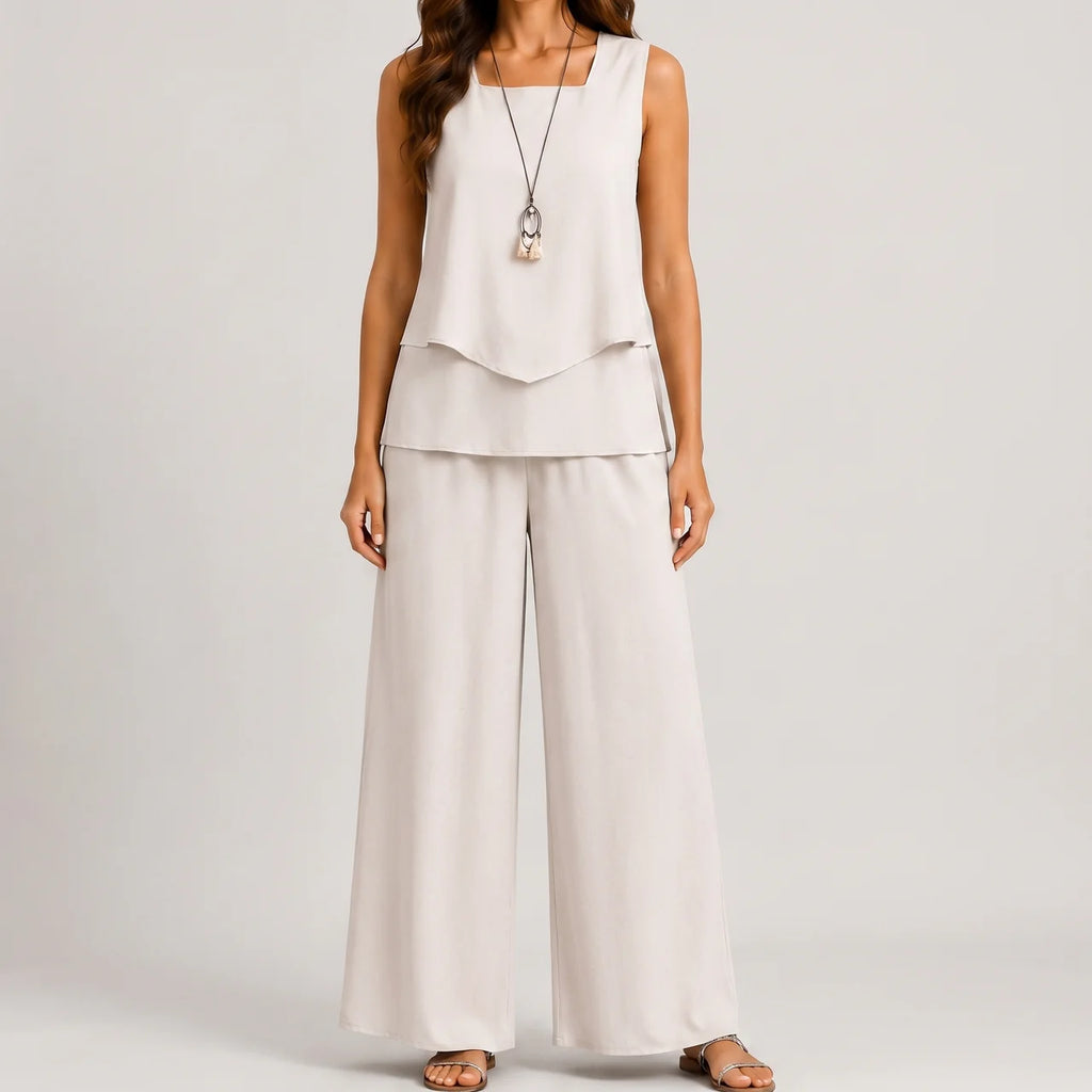 Front view of white layered sleeveless top and wide leg pants set by BELLA HUDSON