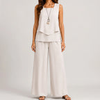Front view of white layered sleeveless top and wide leg pants set by BELLA HUDSON