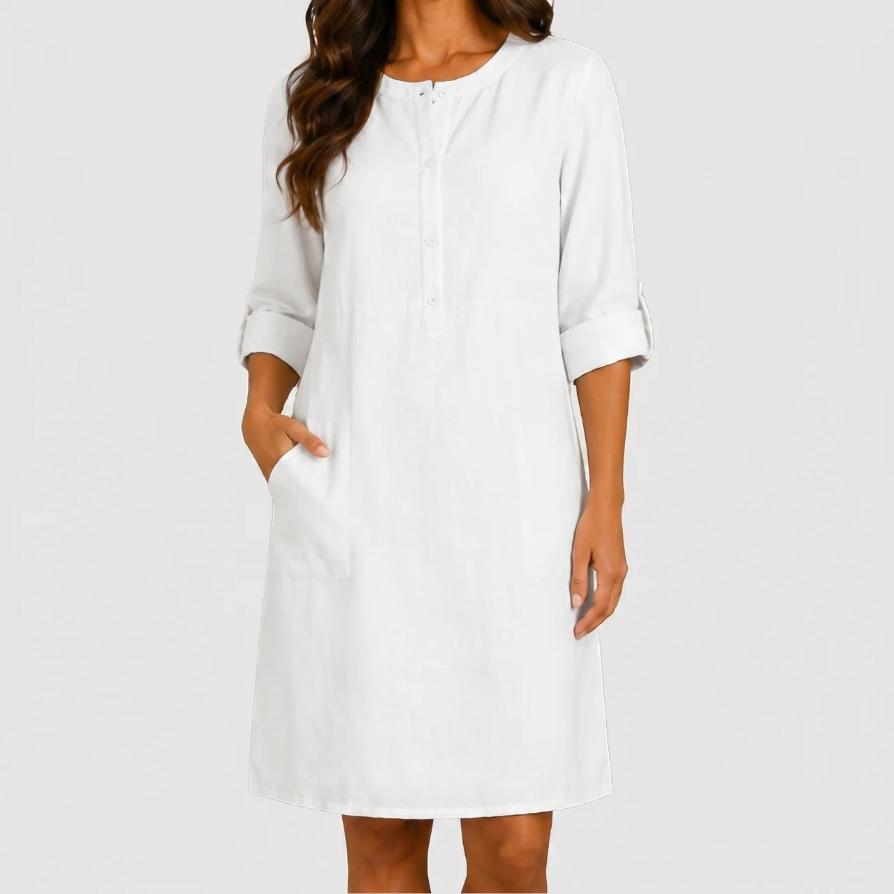 Front view of white linen midi dress with rolled sleeves and side pockets by BELLA HUDSON