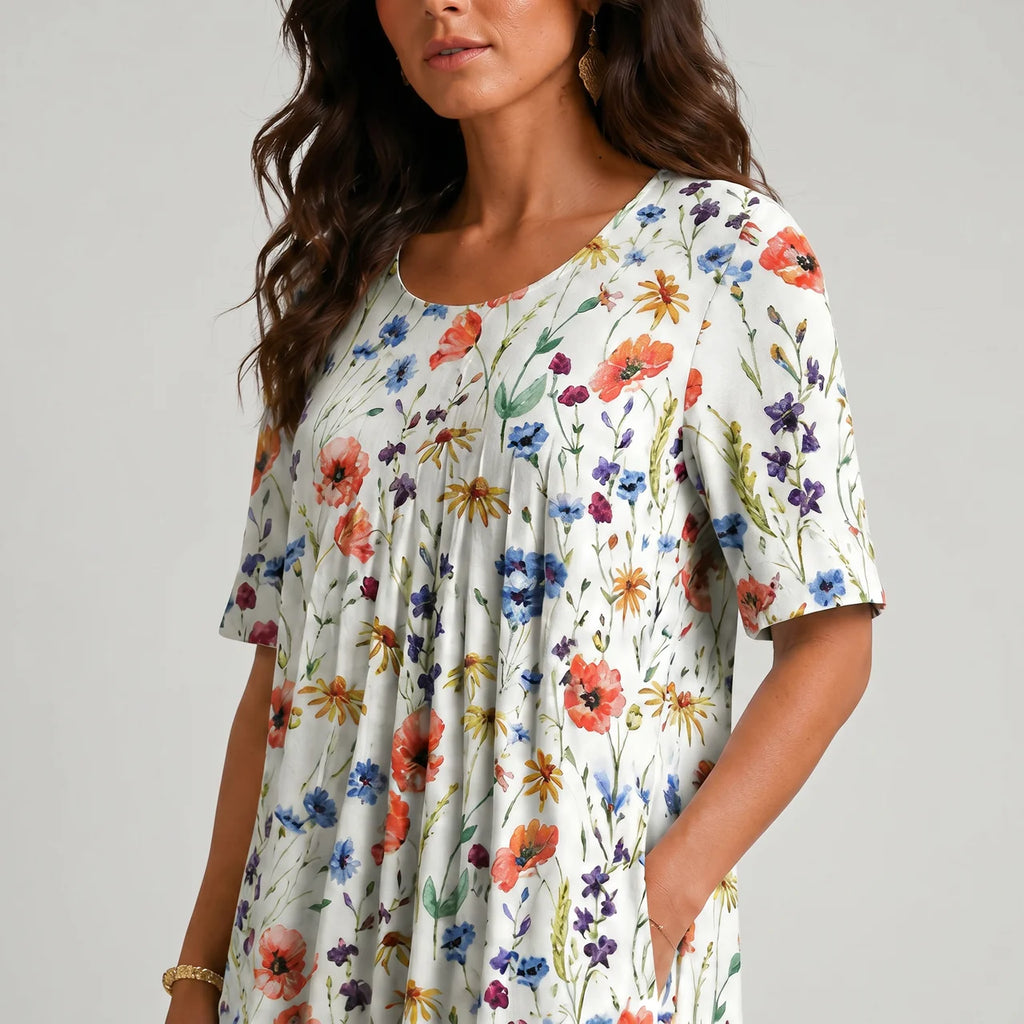 Close-up detail view of white multicolor floral maxi dress with short sleeves and pockets BELLA HUDSON
