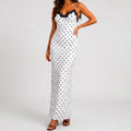 Front view of white polka dot maxi dress with black lace trim and spaghetti straps by BELLA HUDSON