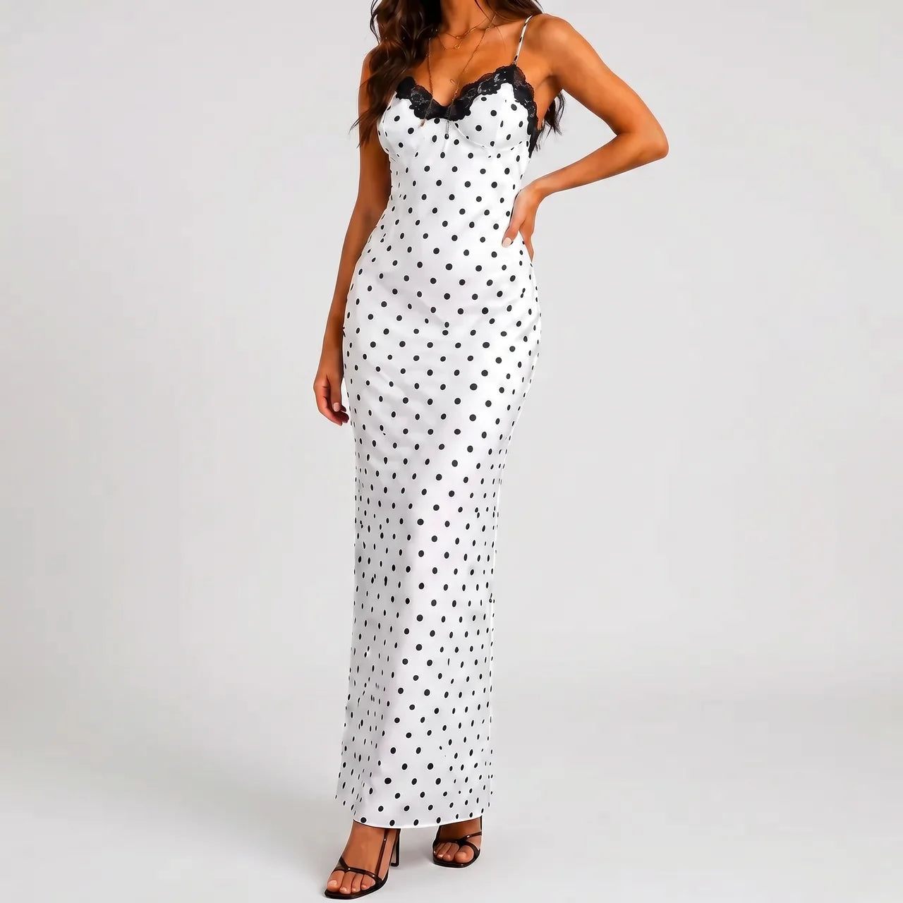 Front view of white polka dot maxi dress with black lace trim and spaghetti straps by BELLA HUDSON