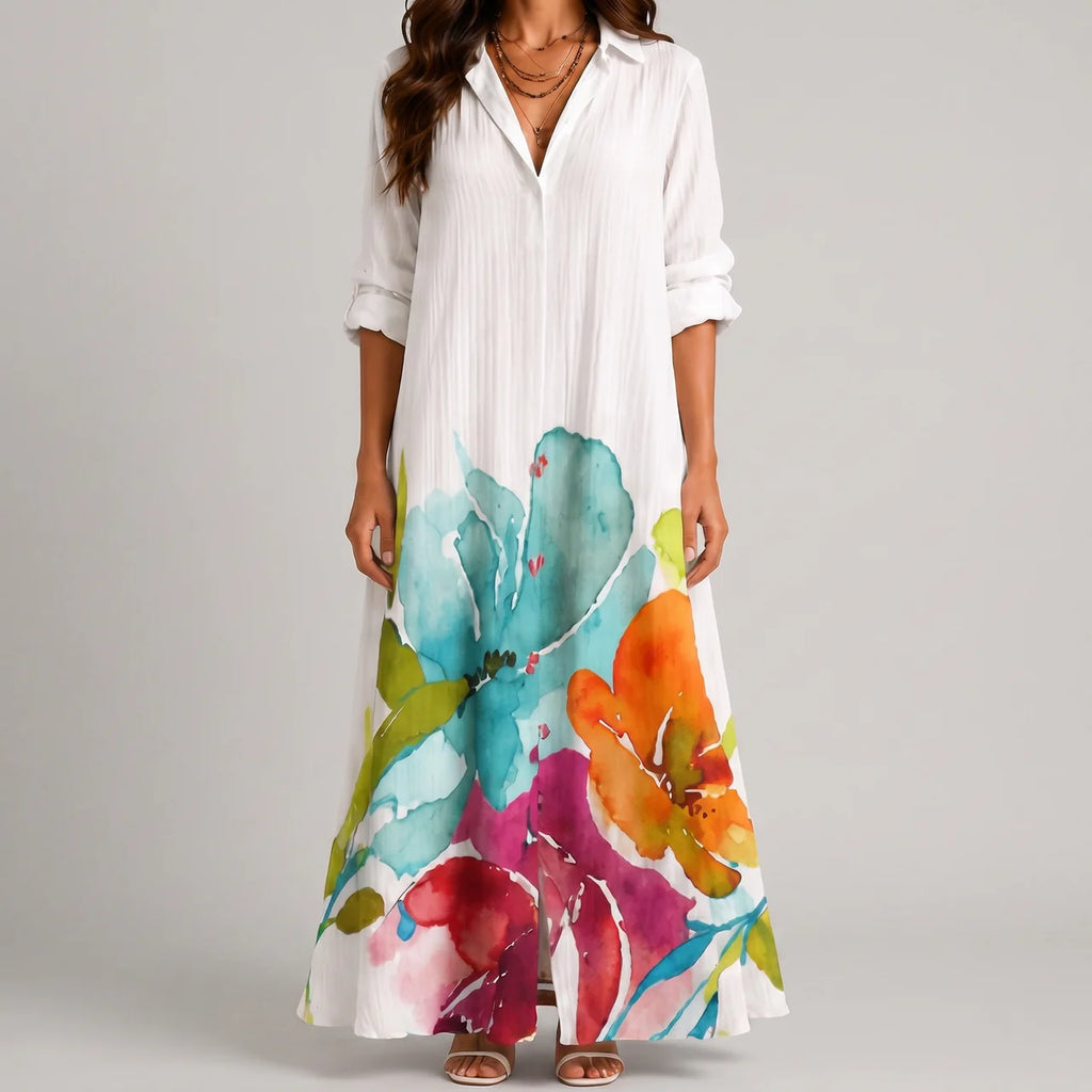 Front view of white watercolor floral maxi dress with vibrant multicolor hem by BELLA HUDSON