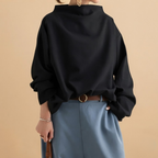 Front view of the Wilhelmina Blouse Draped High-Neck Long-Sleeve in Black, featuring a draped silhouette, high neckline, and long sleeves.
