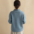 Back view of the Wilhelmina Blouse Draped High-Neck Long-Sleeve in Blue, highlighting the elegant draped silhouette and relaxed fit.