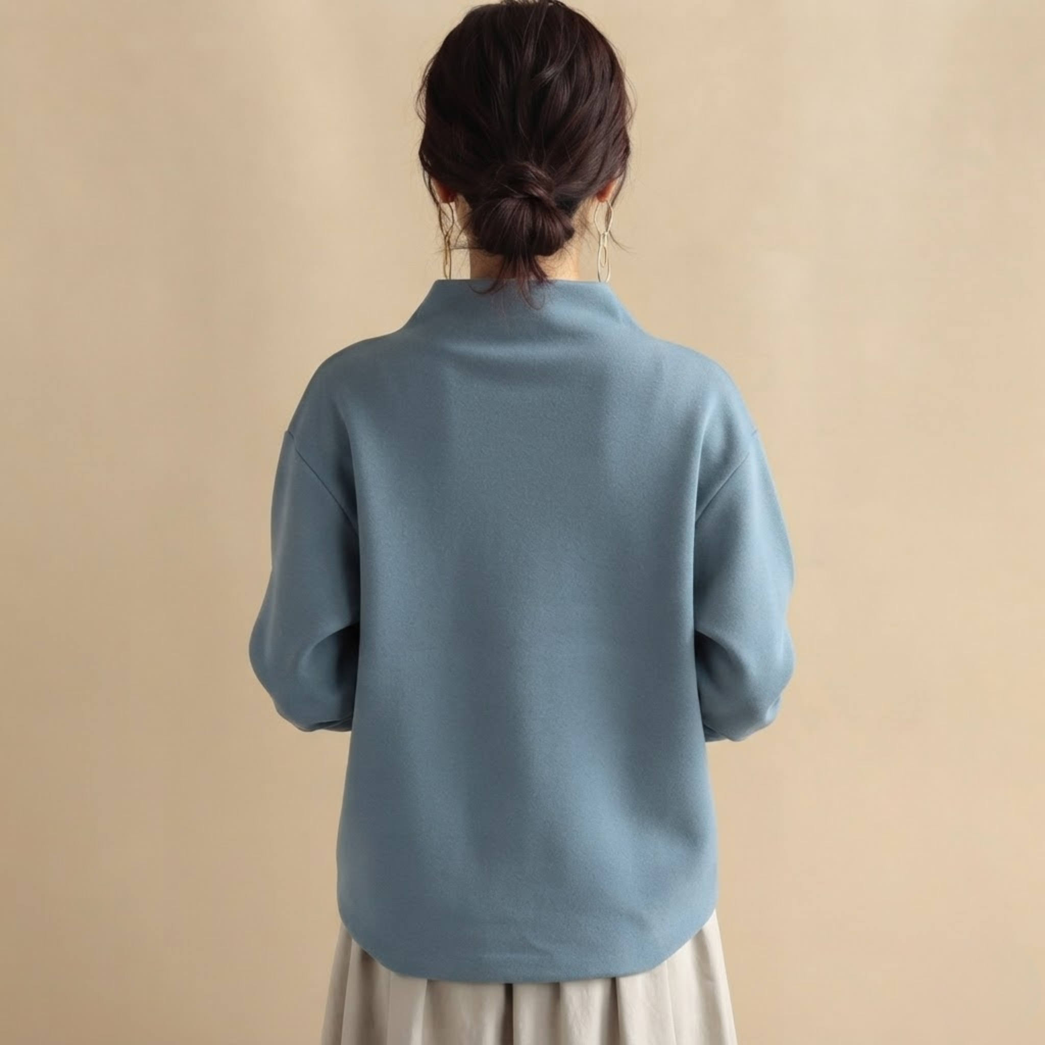 Back view of the Wilhelmina Blouse Draped High-Neck Long-Sleeve in Blue, highlighting the elegant draped silhouette and relaxed fit.