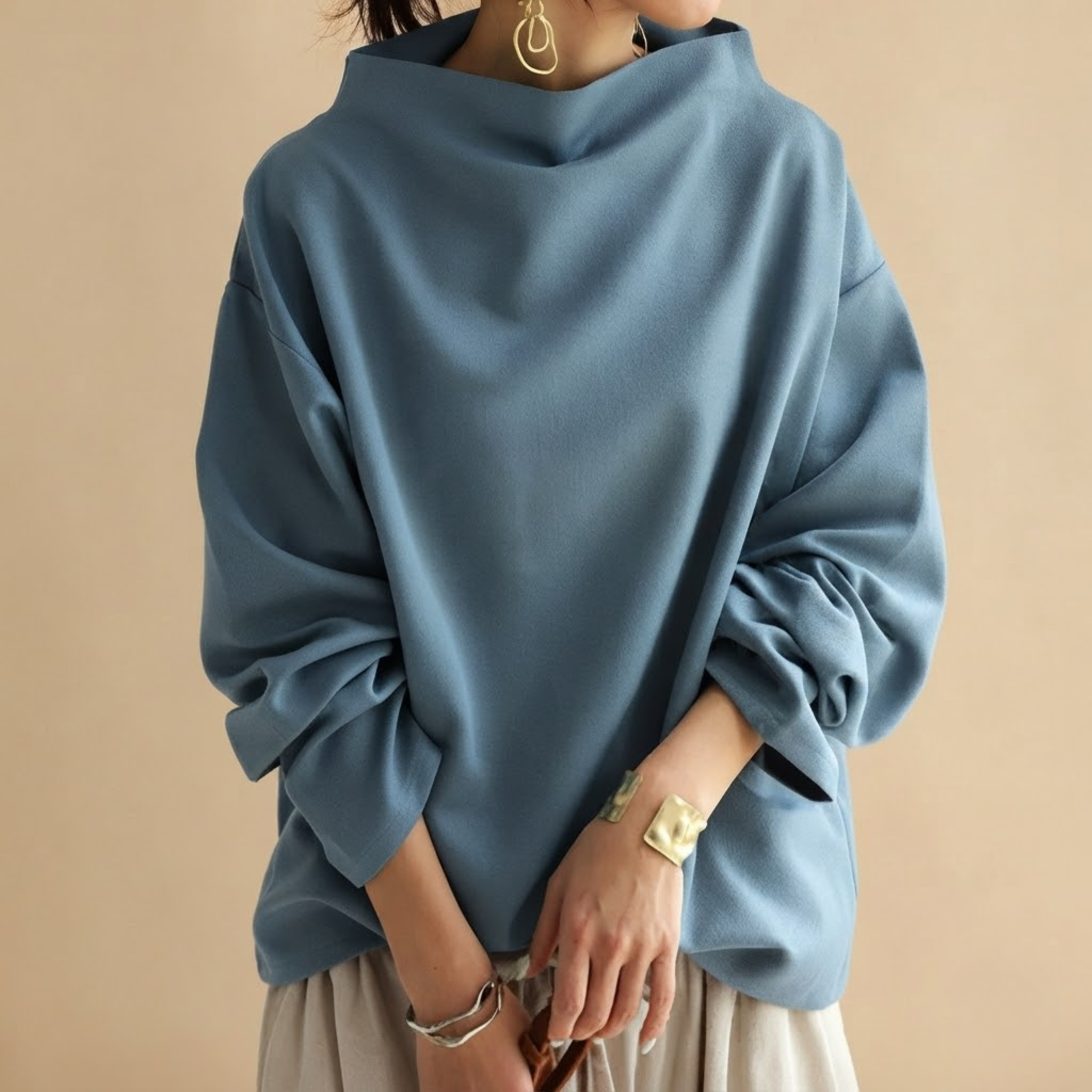 Front view of the Wilhelmina Blouse Draped High-Neck Long-Sleeve in Blue, featuring a draped silhouette, high neckline, and long sleeves.