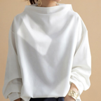 Front view of the Wilhelmina Blouse Draped High-Neck Long-Sleeve in White, featuring a draped silhouette, high neckline, and long sleeves.