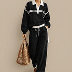 Front view of the Wilhelmina Two-Piece Set Striped Polo Wide-Leg in Black, featuring a striped polo top and relaxed wide-leg pants.