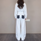 Back view of the Wilhelmina Two-Piece Set Striped Polo Wide-Leg in white, featuring contrast pocket details and relaxed wide-leg trousers. By BELLA HUDSON.