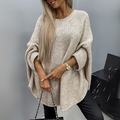 Front view of the Wilhelmine Sweater Oversized Batwing-Sleeve in beige, featuring a round neckline, wide batwing sleeves, textured knit fabric, asymmetrical hem, and an oversized draped silhouette. Designed by Bella Hudson.
