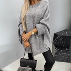 Front view of the Wilhelmine Sweater Oversized Batwing-Sleeve in gray, featuring a round neckline, wide batwing sleeves, textured knit fabric, asymmetrical hem, and a relaxed oversized silhouette. Designed by Bella Hudson.