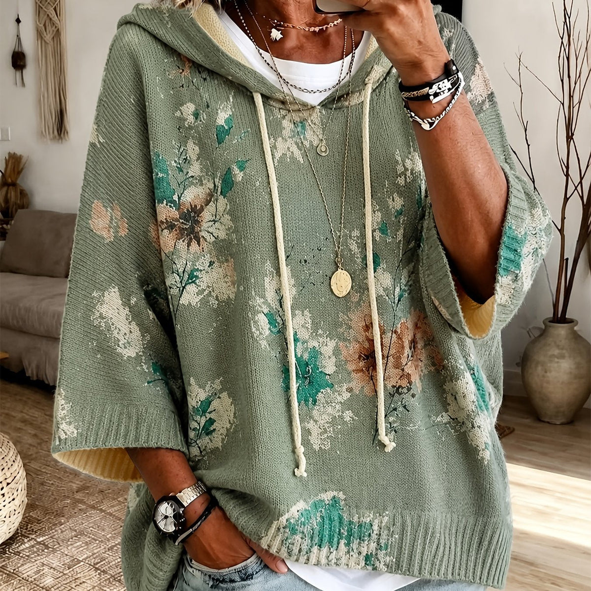 Winifred Green hooded floral cape sweater with floral detailing, drawstring hood, wide cape-style sleeves, and an easy draped fit