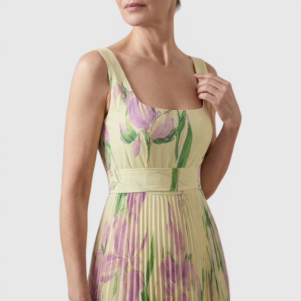 Close-up detail of the Winnie Maxi Cocktail Dress Floral-Print Chiffon Square-Neck in yellow, featuring the square neckline, fitted bodice, delicate floral print, and lightweight chiffon fabric. Designed by Bella Hudson.