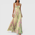 Flowing view of the Winnie Maxi Cocktail Dress Floral-Print Chiffon Square-Neck in yellow, showcasing the airy chiffon skirt, soft floral print, and elegant movement. Designed by Bella Hudson.