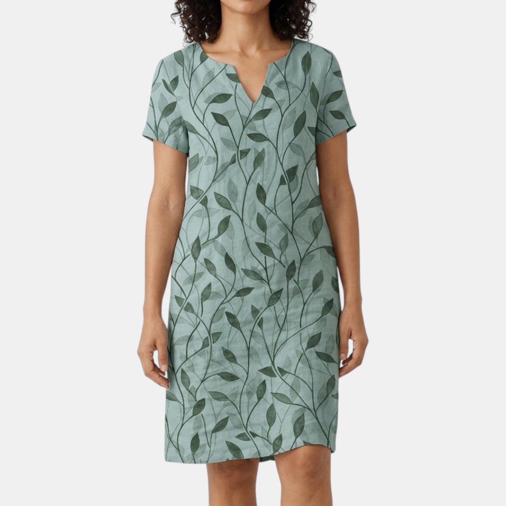 Front view of the Winnie Shift Dress Leaf-Print Lightweight Short-Sleeve in green, featuring a V-neckline, short sleeves, an all-over leaf print, side pockets, and a relaxed shift silhouette. Designed by Bella Hudson.
