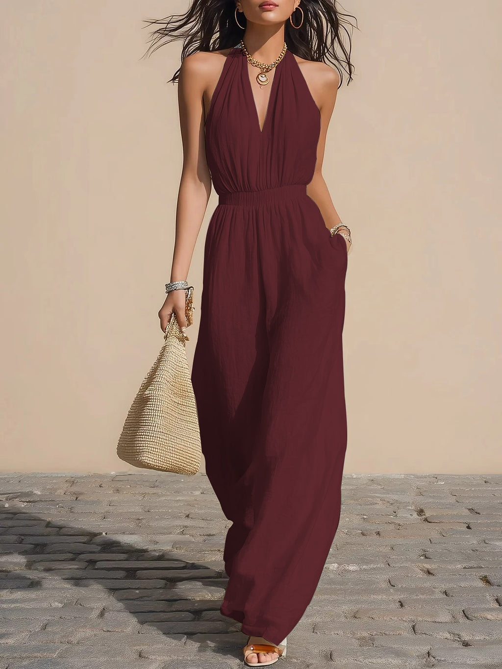 Front view of the Winnifred Maxi Dress Halter Open-Back in red, featuring a plunging V-neckline, halter-style bodice, defined waist, side pockets, and a flowing floor-length silhouette. Designed by Bella Hudson.