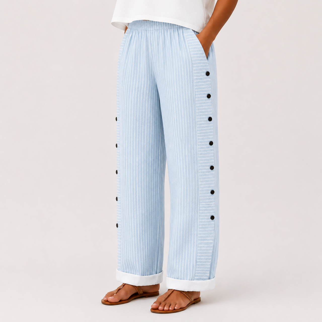 Light blue front view of Woman's Lightweight Pants with Button Design showcasing striped fabric and decorative side buttons, designed by Bella Hudson