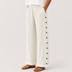White front view of Woman's Lightweight Pants with Button Design featuring side button details and a relaxed wide-leg silhouette, designed by Bella Hudson