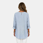 Back view of the Women's Boho Lightweight Blouse in blue, highlighting the loose oversized fit, textured fabric, and rounded high-low hemline. Designed by Bella Hudson.