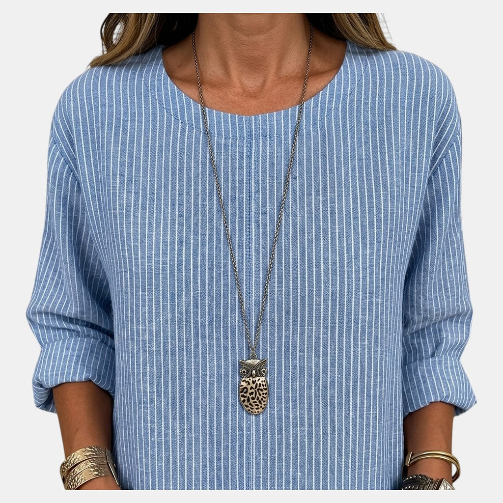 Close-up detail of the Women's Boho Lightweight Blouse in blue, featuring the textured fabric, round neckline, and soft crinkled finish. Designed by Bella Hudson.
