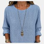 Close-up detail of the Women's Boho Lightweight Blouse in blue, featuring the textured fabric, round neckline, and soft crinkled finish. Designed by Bella Hudson.