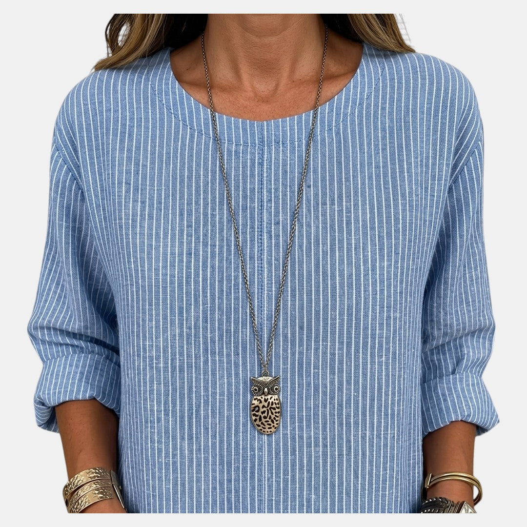 Close-up detail of the Women's Boho Lightweight Blouse in blue, featuring the textured fabric, round neckline, and soft crinkled finish. Designed by Bella Hudson.