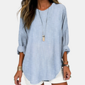 Front detail view of the Women's Boho Lightweight Blouse in blue, showcasing the relaxed fit, rolled sleeves, textured fabric, and curved hem. Designed by Bella Hudson.