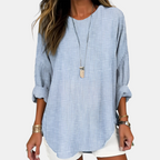 Front detail view of the Women's Boho Lightweight Blouse in blue, showcasing the relaxed fit, rolled sleeves, textured fabric, and curved hem. Designed by Bella Hudson.