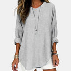 Front view of the Women's Boho Lightweight Blouse in gray, featuring a loose oversized silhouette, round neckline, rolled sleeves, textured fabric, and a flattering high-low hem. Designed by Bella Hudson.