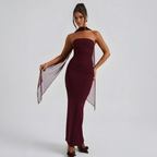 Front view of the Women's Cocktail Maxi Dress Bodycon Fit with Styled Scarf in burgundy, featuring a strapless neckline, figure-hugging silhouette, sheer scarf accent, and elegant floor-length styling. Designed by Bella Hudson.
