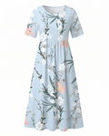 Front view of light blue floral print midi dress with short sleeves, empire waist and pockets by BELLA HUDSON