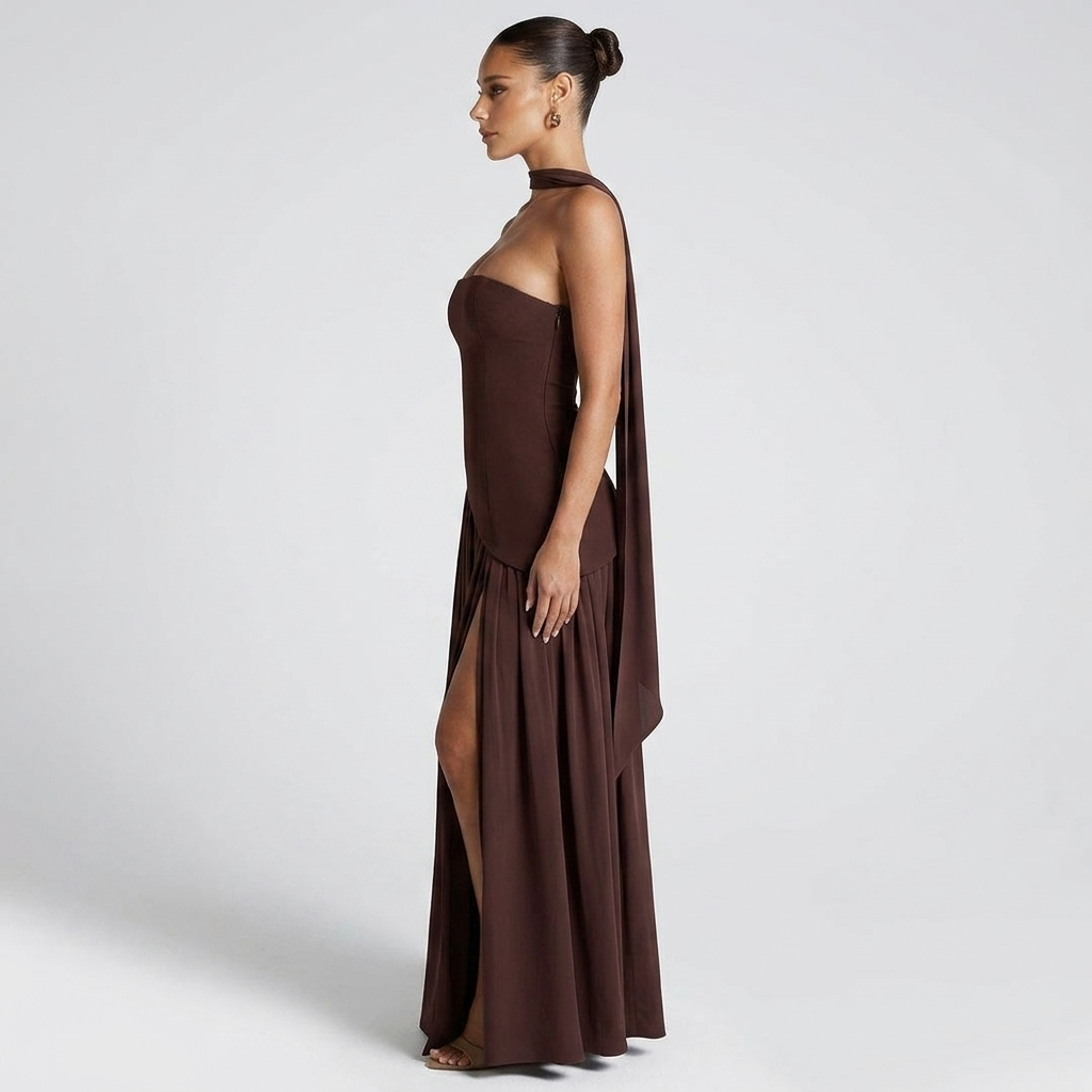 Side view of the Women's Wedding Guest Maxi Dress with a strapless bodice and high-split design in brown, showcasing the clean strapless back, gathered waistline, and graceful full-length silhouette. Designed by Bella Hudson.