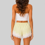 Back view of yellow A lace trim bloomer shorts with elastic waist and layered ruffle design by BELLA HUDSON