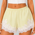 Close-up view of yellow A lace trim bloomer shorts with elastic waist and layered ruffle design by BELLA HUDSON