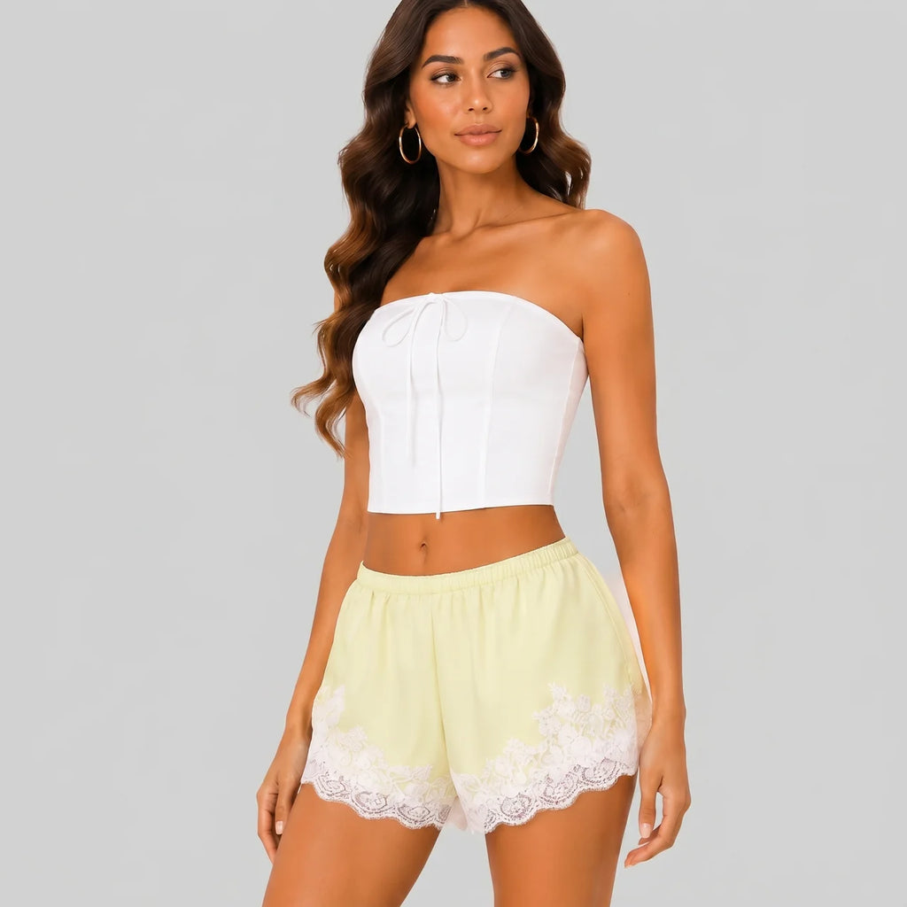 Side view of yellow A lace trim bloomer shorts with elastic waist and layered ruffle design by BELLA HUDSON