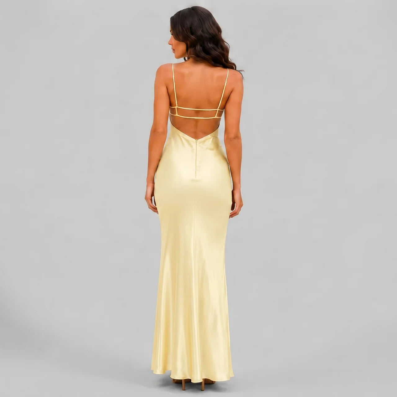 Back view of yellow satin maxi dress with spaghetti straps and bodycon silhouette by BELLA HUDSON