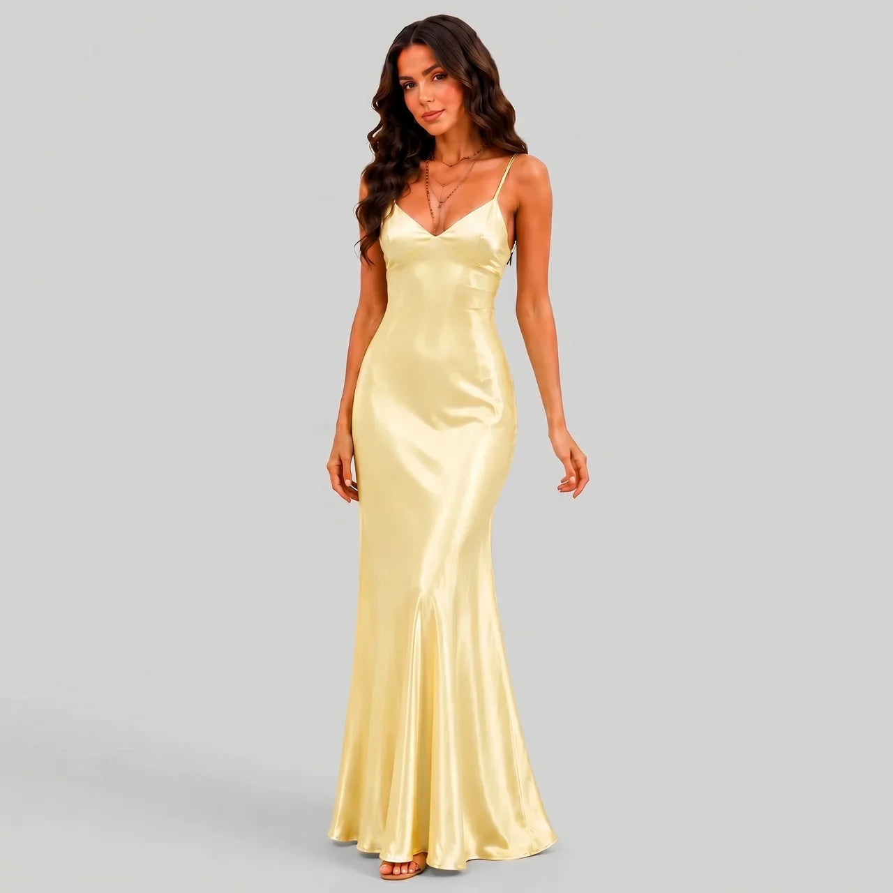 Side view of yellow satin maxi dress with spaghetti straps and bodycon silhouette by BELLA HUDSON